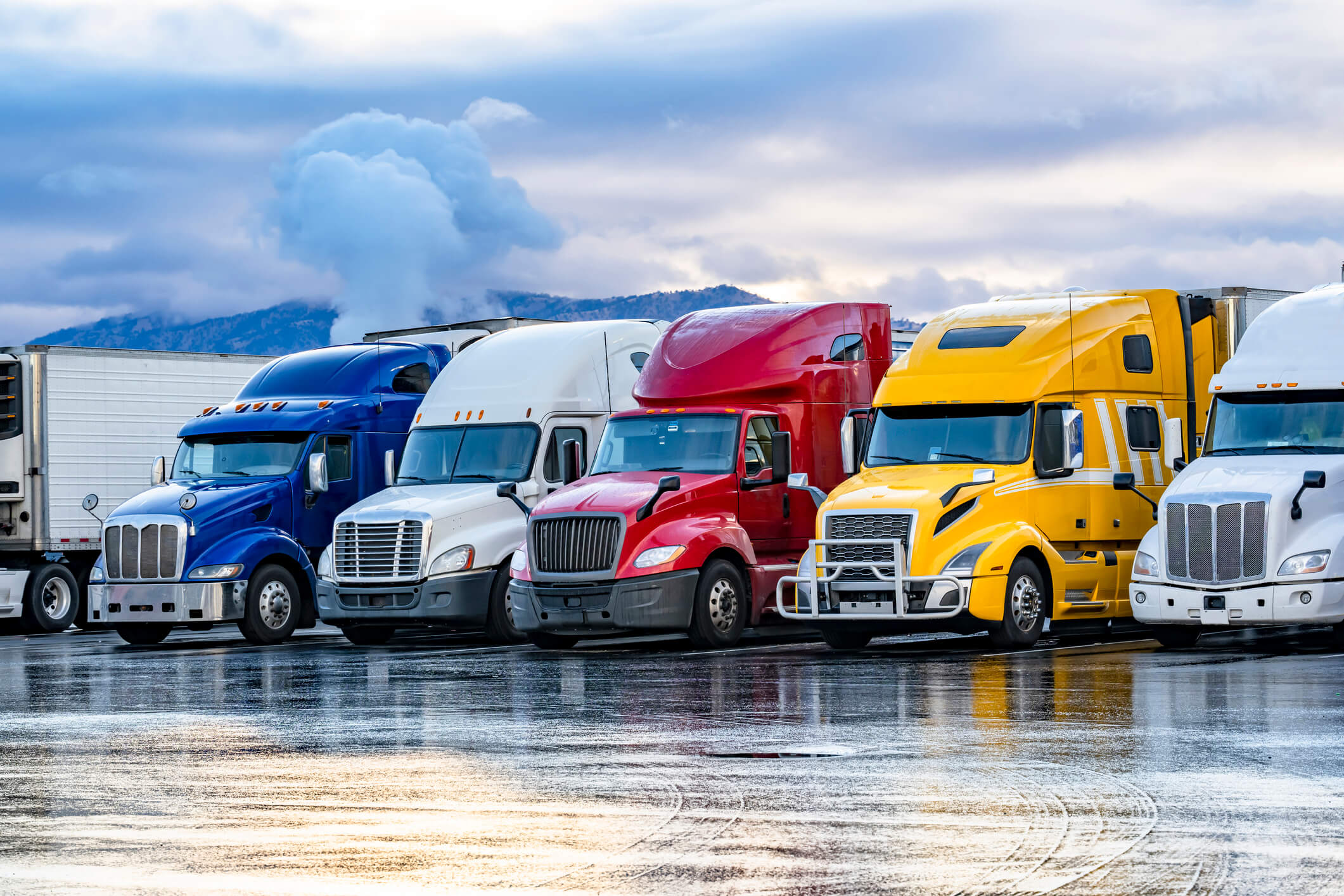 Colorful semi-trucks parked in a row.