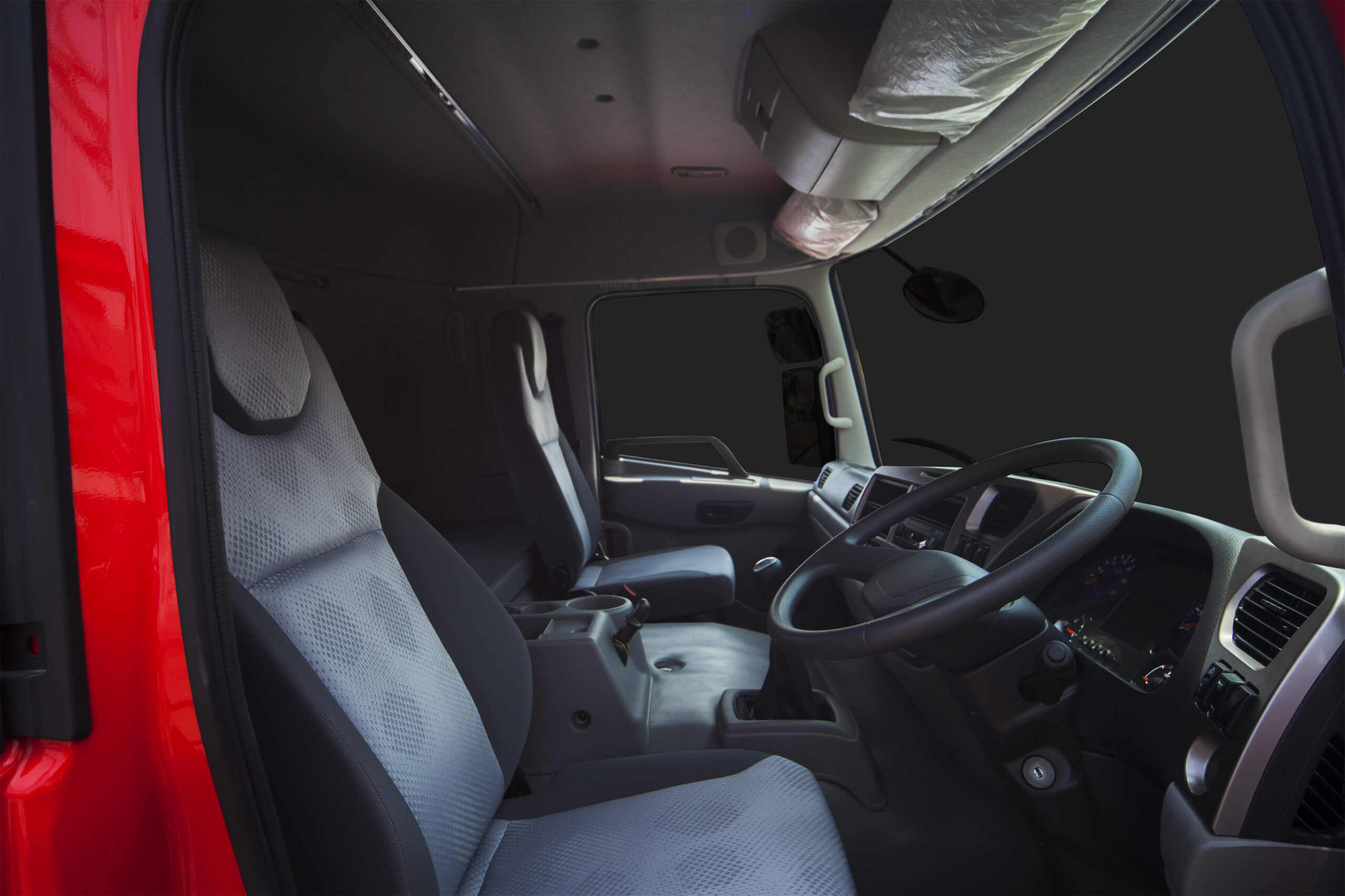 Red truck cab interior with gray seats.